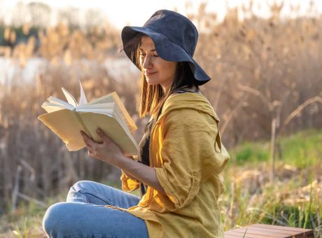 stylish-girl-with-a-book-in-her-hands-reads-at-sunset-.jpg